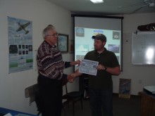 Instructor Dennis Mathis presents BJ Finney with his EOC certificate.