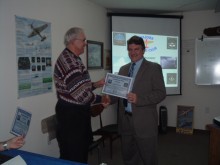 Instructor Dennis Mathis presents Brett Pelham with his EOC certificate.