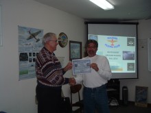 Instructor Dennis Mathis presents Denis Rottler with his EOC certificate.